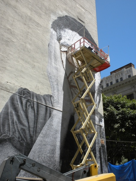 Mural located in Downtown Los Angeles, by Vhils. Shot shows the size and scope of the image. Mural located in Downtown Los Angeles, by Vhils. Shows the size and scope of the image.